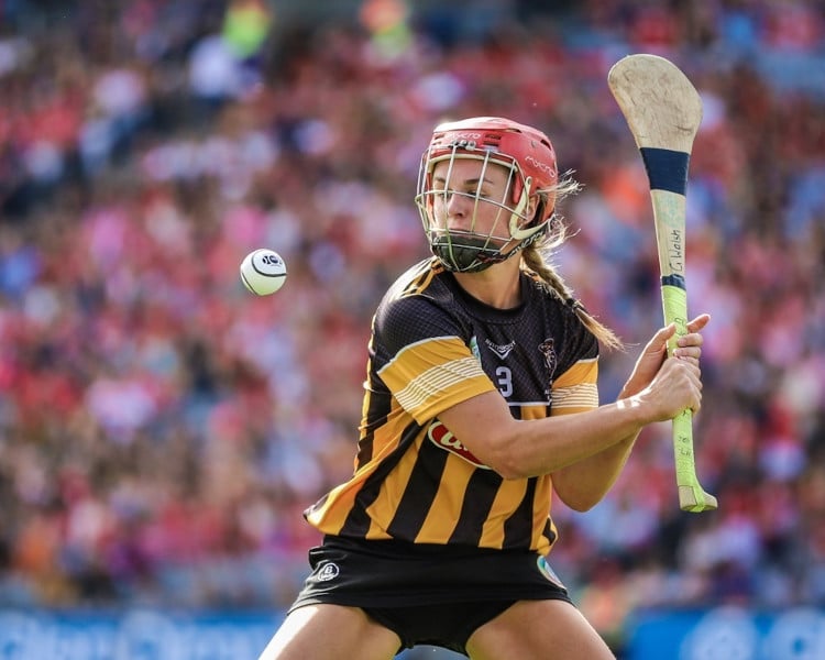 a hurling player hitting a ball